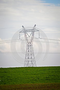 High voltage electric pillar, grass and sky