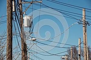 High Voltage Electric Pole with Fuse and Power Cable with bright blue sky