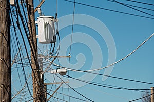 High Voltage Electric Pole with Fuse and Power Cable with bright blue sky