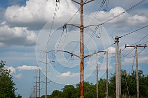 High Voltage Electric Pole with Fuse and Power Cable with bright blue sky as the background