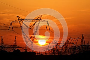 High voltage electric pole during sunset