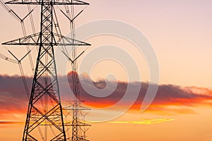 High voltage electric pole and transmission lines in the evening. Electricity pylons at sunset. Power and energy. Energy