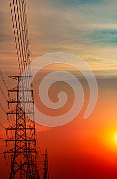 High voltage electric pole and transmission lines in the evening. Electricity pylons at sunset. Power and energy. Energy