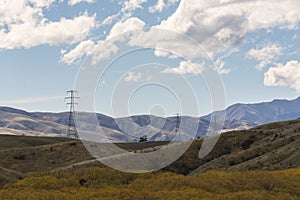 High voltage electric pols in mountain range. photo