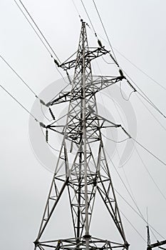 High voltage electric power steel tower in the evrning time, closeup of photo