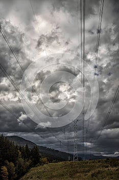High voltage electric pylon and electrical wire. Electricity pylon with cloudy sky. High voltage grid tower with wire cable