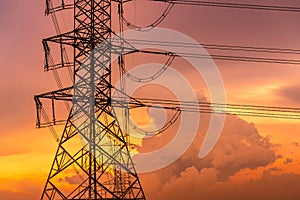 High voltage electric pylon and electrical wire with sunset sky. Electricity pole. Power and energy concept. High voltage grid