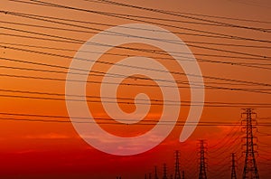 High voltage electric pylon and electrical wire with sunset sky. Electricity poles. Power and energy support factory concept. High