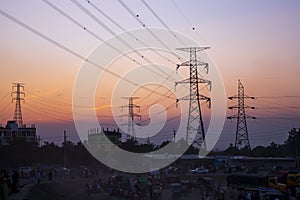 High Voltage electric pylons with colorful landscapes after sunset photo