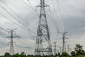 High voltage electric pylons and power lines through a field