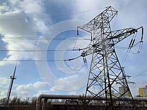 High voltage electric tower against the blue sky. High steel power transmission pole in production