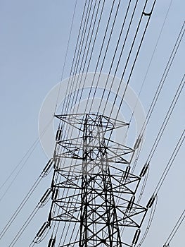 High voltage electric tower against a clear blue sky.