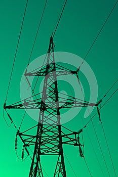 High voltage electric tower silhouette on bright green background