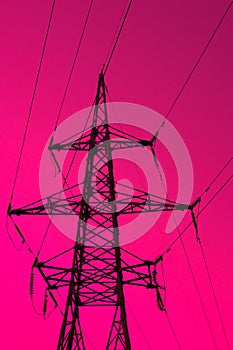 High voltage electric tower silhouette on bright red background