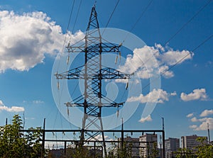 High voltage electric transmission line and pylon against cityline