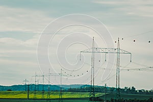 High voltage electric transmission pylon silhouetted. Electricity transmission pylon silhouetted against blue sky. High voltage