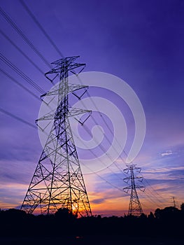 High Voltage Electric Transmission Tower Energy Pylon in sunset background