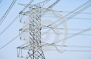 High voltage electric transmission tower. High voltage power lines against the sky. Electricity pylon and electric power