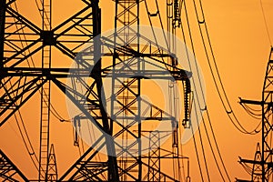 High voltage electric transmission tower. High voltage power lines on electric pylon against a sunset sky. Electrical