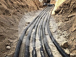 The high voltage electrical cable is laid in a trench