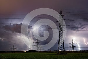 High voltage electrical mast with lightning storm over Prague, Czech republic