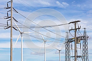 High voltage electrical power pylon substation with wind turbines renewable wind energy