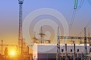 High voltage electrical substation in the rays of the setting sun