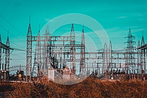 High voltage Electrical substation with steel frames, insulators and electricity transmission power lines and blue sky background