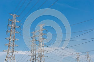 High voltage electrical tower blue sky background.