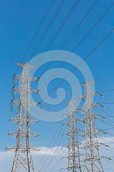 High voltage electrical tower blue sky background.