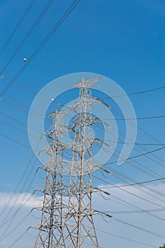 High voltage electrical tower blue sky background.
