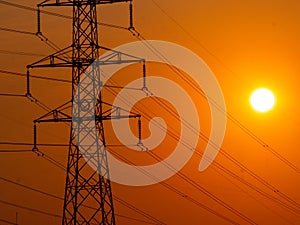 high voltage electrical tower during sunset