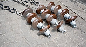 High voltage electricity cable connected with brown ceramic insulators