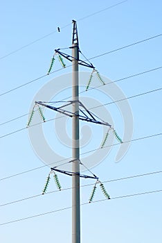 High voltage electricity pillars on the blue sky background