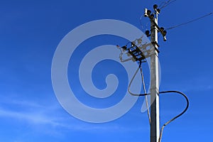 High Voltage Electricity Pillars Cables On Electricity Power Tower On Blue Sky Background. Transmission Lines.