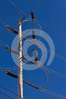 High voltage electricity pole in blue sky