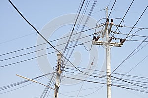 High voltage electricity pole in blue sky background