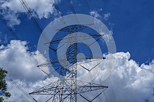 High voltage electricity poles against a clear blue sky