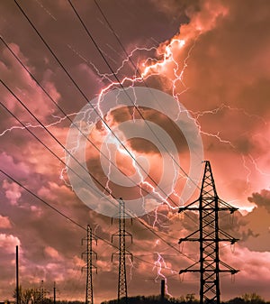 High voltage electricity power line towers against thunderstorm sky. Transmission towers