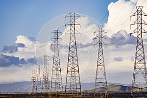 High voltage electricity power lines and transmission towers crossing the ponds and marshes of south San Francisco Bay area,