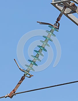 High-voltage electricity pylon against blue sky