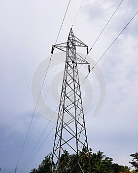 High voltage electricity pylon standing against sky