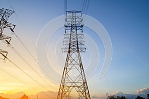High voltage electricity pylon system at sunset