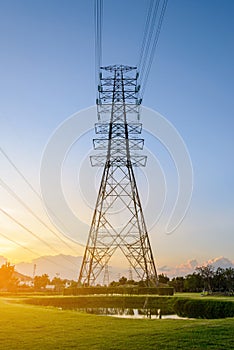 High voltage electricity pylon system at sunset