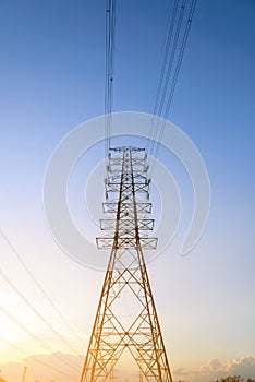 High voltage electricity pylon system at sunset