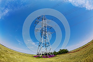 High-voltage electricity pylons against blue sky