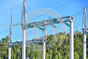High voltage electricity pylons against perfect blue sky with white clouds. electric poles