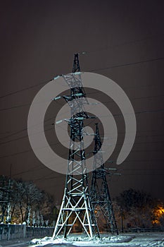 High-voltage electricity pylons and power lines at Night sky