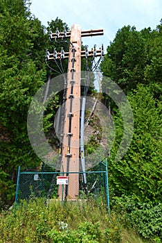 High voltage electricity tower or pylon a steel lattice tower support overhead power line. Electricity transmission in mountain