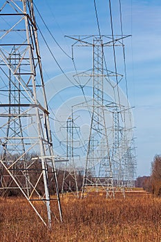 High voltage electricity towers deliver electricity into the horizon